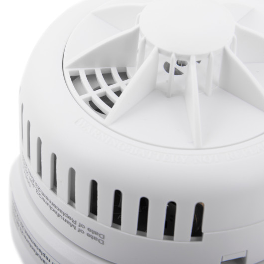 Closeup of the sounder part of the ultrafire radio interlinked 10yr battery heat alarm showing vents and circular design