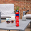 ultrafire 600g powder extinguisher standing on an outdoor table with cups and sunglasses in the background
