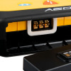 Close‑up of an AED connector port with metallic contacts and part of the yellow and black casing visible around the interface.