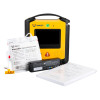VIVEST AED kit including the main defibrillator unit, sealed disposable pads, a battery pack, and an instruction booklet arranged in front.