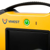 Close‑up of a yellow VIVEST device showing the brand logo, black screen, green illuminated power button, and indicator light.