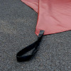 Close-up of deployment handles on a bridgehill single use car fire blanket laid out on the ground