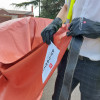 Person wearing gloves holding a folded car fire blanket for electric vehicles Bridgehill outdoors