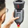Person holding the testifire xtr2 detector tester head with a finger pressing a button on the device