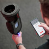 testifire xtr2 detector tester head held in hand alongside a mobile phone showing app controls