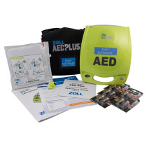 A bright yellow defibrillator with all its contents spread out
