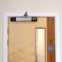 Silver Agrippa door closer on fire door