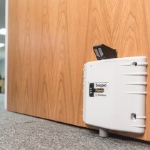 White Dorgard SmartSound fire door retainer installed on an office door