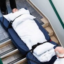 Descend stairs while keeping the patient safe from injury