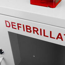 Easily identifiable with bold red "DEFIBRILLATOR" lettering